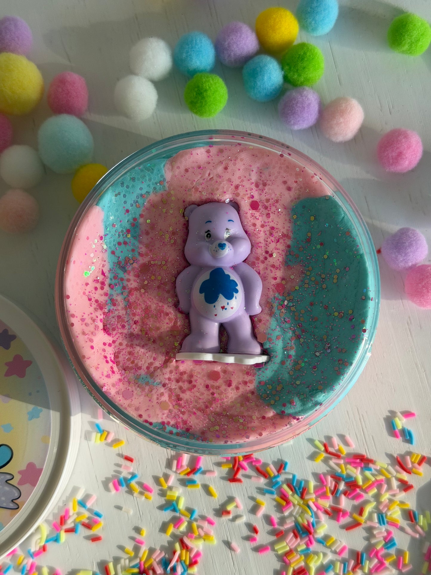 Pastel blue and pink playdough with a Care Bears Figurine