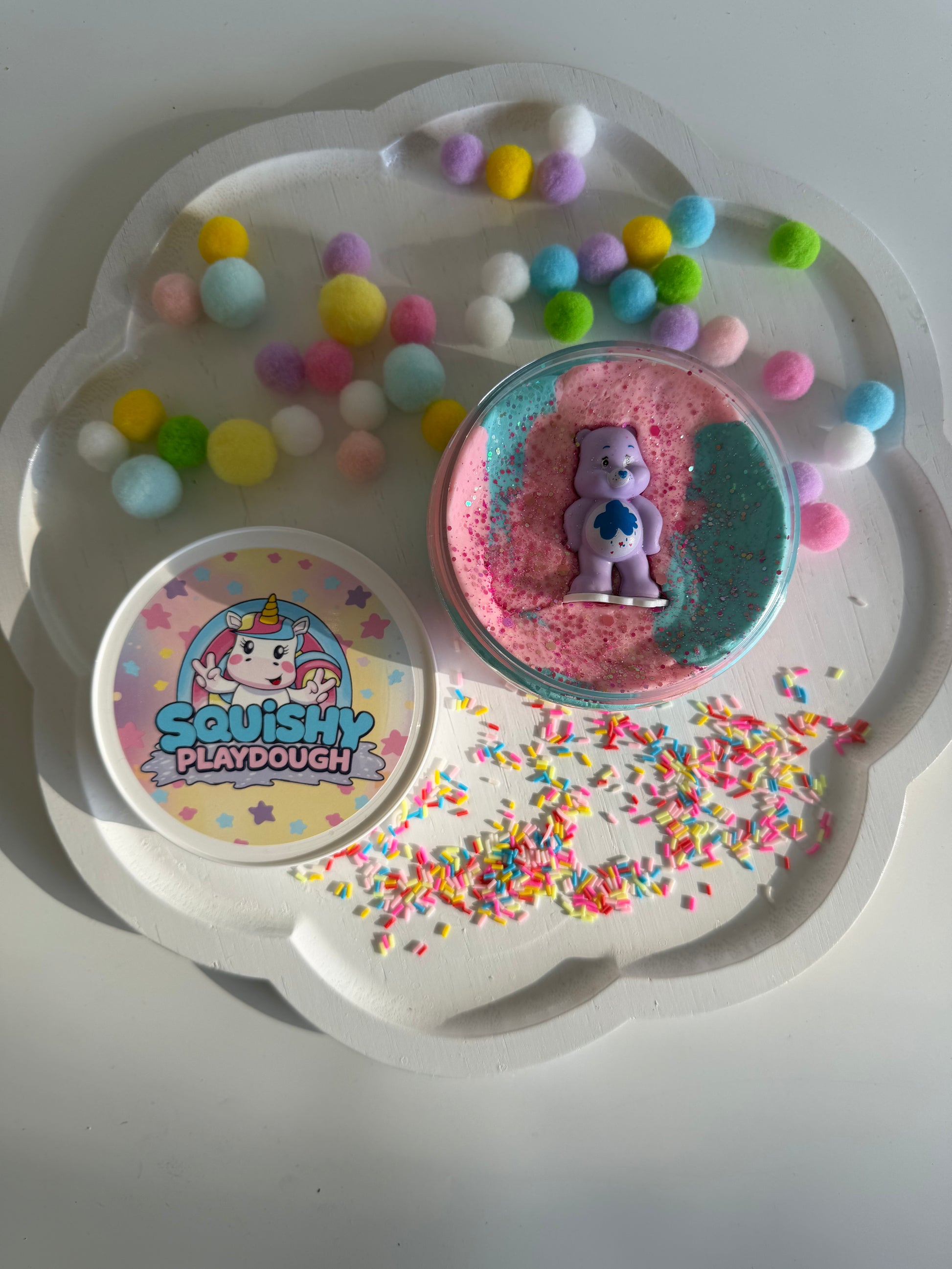 Pastel blue and pink playdough with a Care Bears Figurine